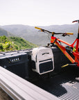 Red bicycle on a truck bed with mountains in the background