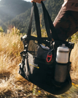 person holding black totebag