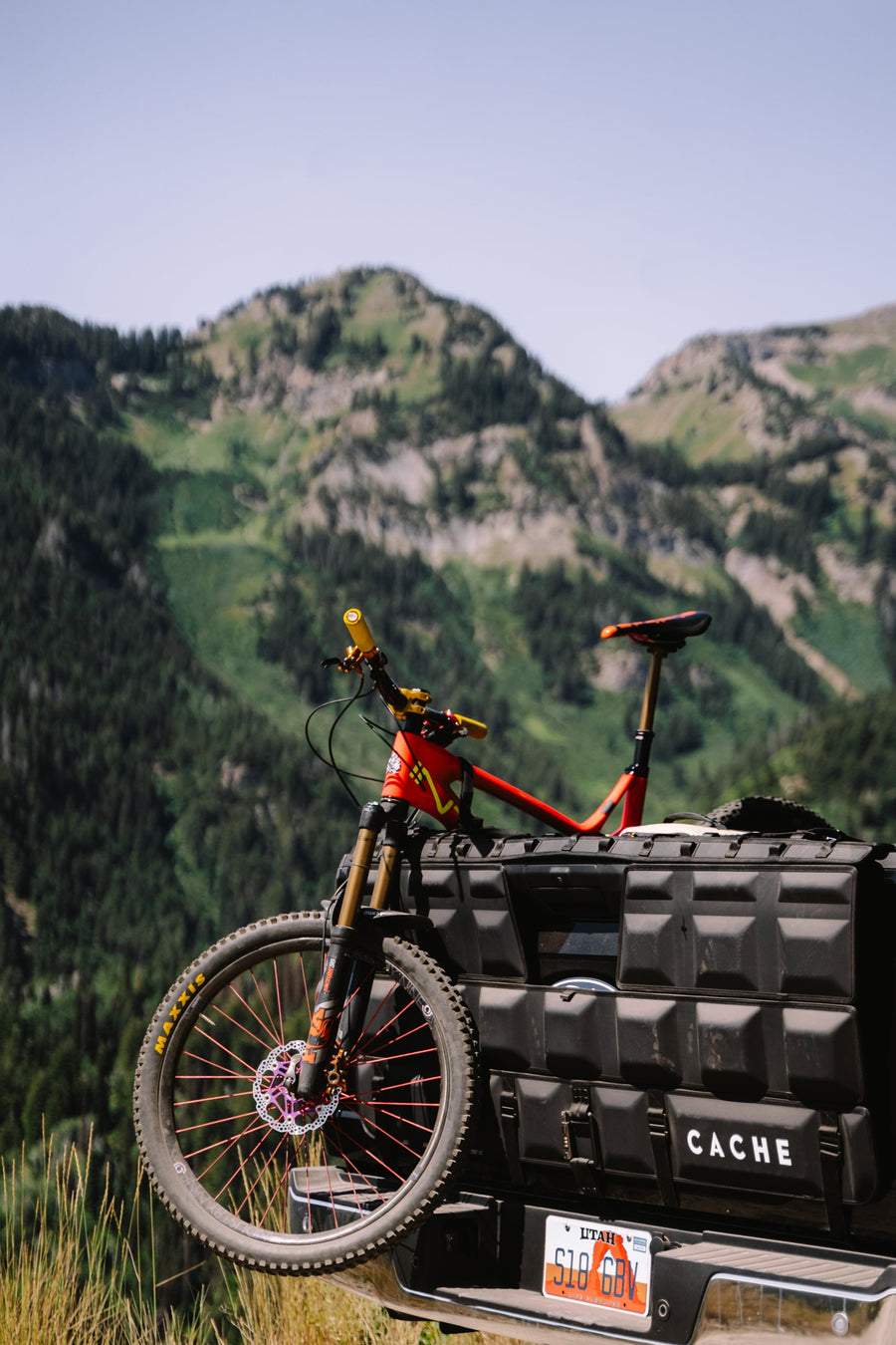 Bicycle on a Cache truck bed with mountains in the background
