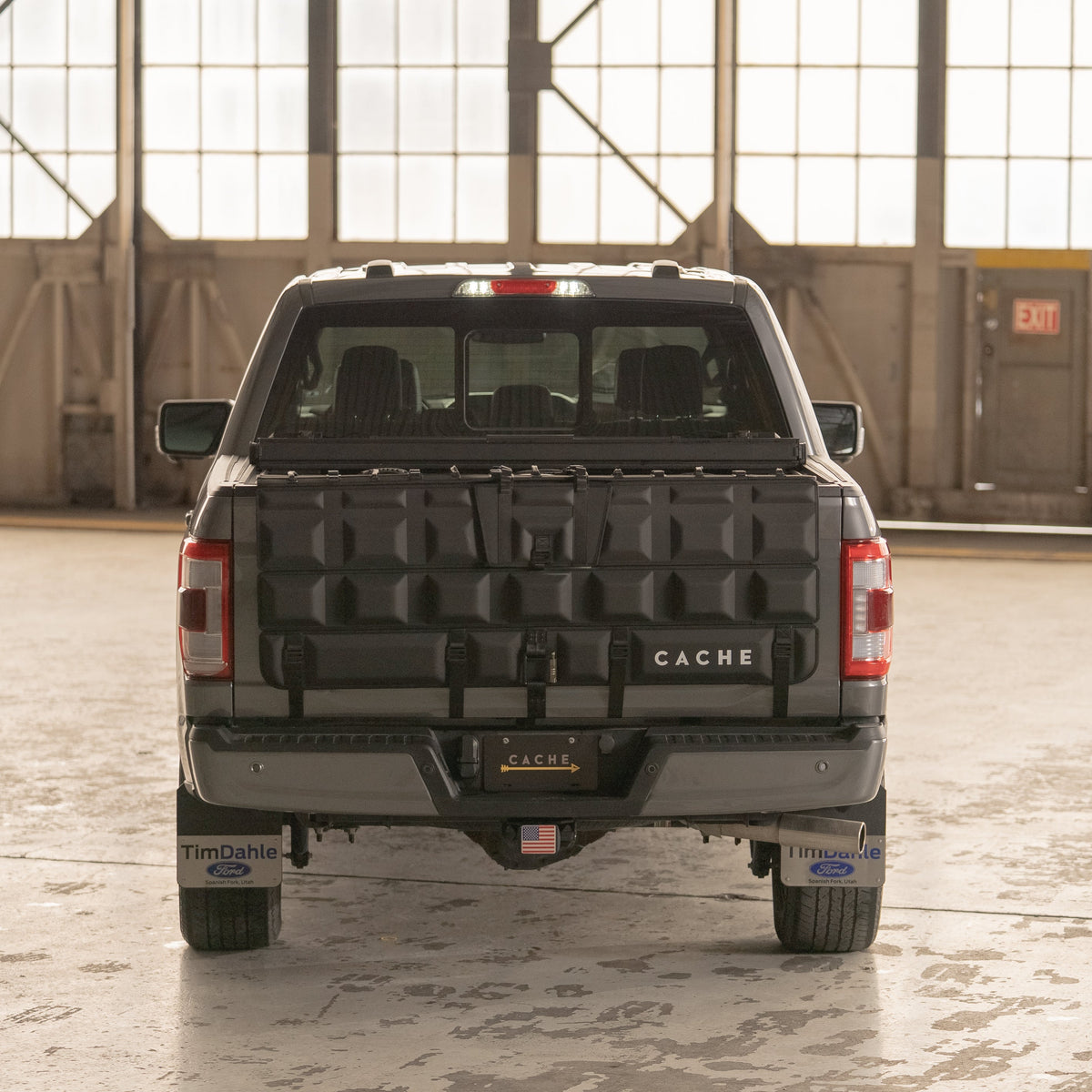 Back view of a truck with a Cache bed cover in an indoor setting