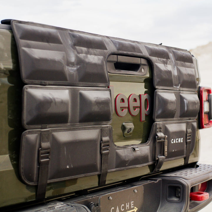 Jeep tailgate with a cargo cover in a desert setting