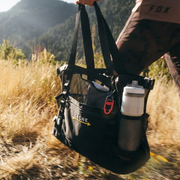 person holding black totebag
