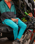 Close-up of mountain bikes attached to a padded tailgate pad on a parked truck